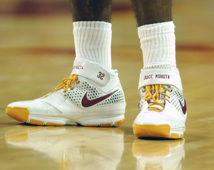 View of white and gold Nike Kobe shoes.